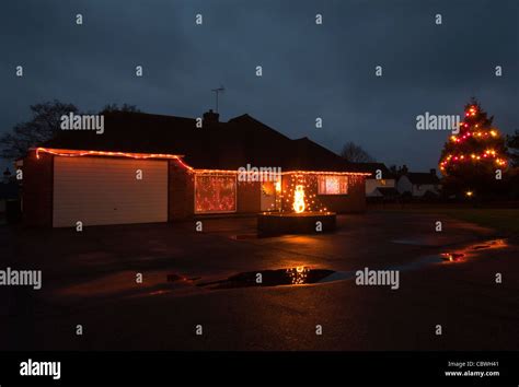Exterior Of A House Lit Up With Christmas Lights At Dusk Home Property