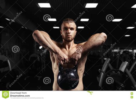 fitness man doing a weight training by lifting heavy kettlebell stock image image of