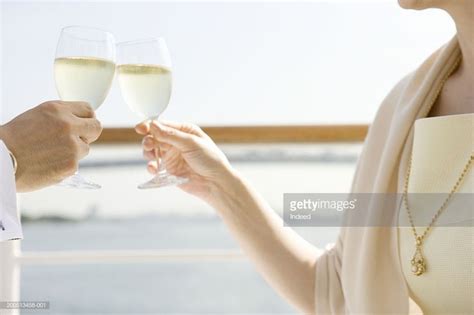 mature couple toasting on deck of cruise ship close up mid section cruise cruise ship