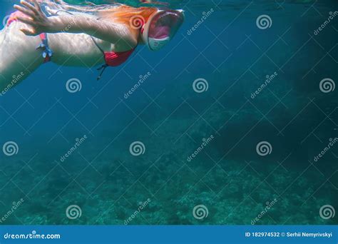 Girl In A Full Face Mask For Snorkeling Under The Water Dives To The