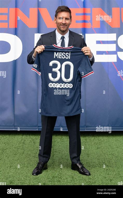 Argentinian Football Player Lionel Messi Holds Up His Number 30 Shirt