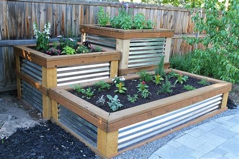 Garden beds made out of corrugated iron are increasingly popular. Build Your Own Raised Herb Garden on twopeasandtheirpod.com
