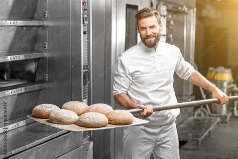 Handsome Baker In Uniform Taking Out With Shovel Freshly Baked Buckweat