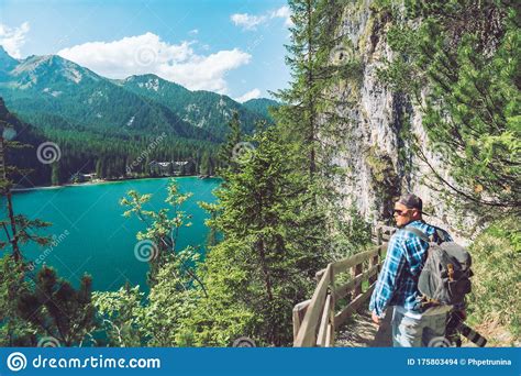 Man Walking By Hiking Trail Around Braies Lake In Italy Dolomites