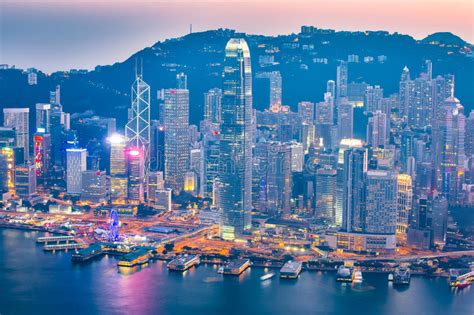 Night At The Victoria Harbor In Hong Kong City Skyline Stock Photo