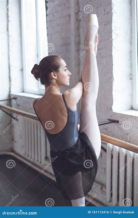 Young Ballet Dancer Stretching Leg Up In Studio Active Lifestyle Stock