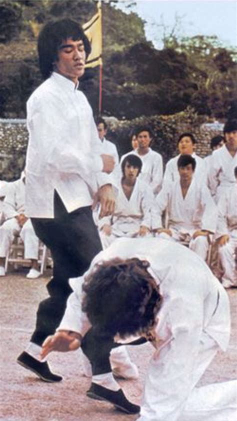 Bruce Lee and Jackie Chan in a fighting Match that is Jackie being the
