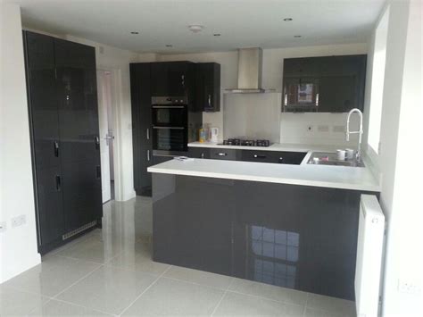 Suppliers and sellers understand that different people's needs and preferences about their kitchens vary. Charcoal grey gloss kitchen units, white worktops and grey ...