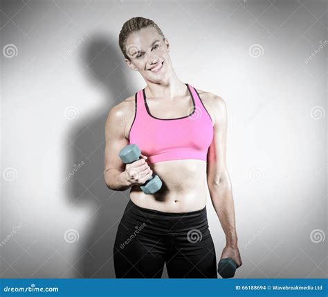 Composite Image Of Muscular Woman Lifting Heavy Dumbbells Stock Photo
