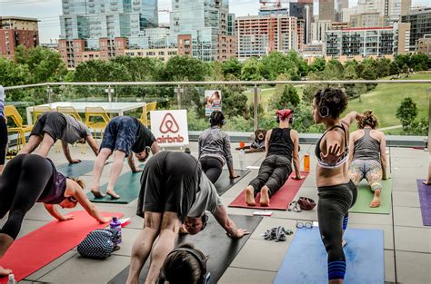 Yoga Women And Yoga Men Doing Smooth Yoga Flows Over The Denver City