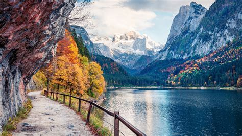 Landscape View Of Snow Covered Mountains And River Between Trees