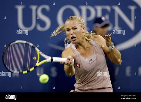 Caroline Wozniacki Of Denmark Returns The Ball To Kim Clijsters Of
