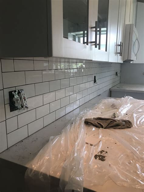 The materials can be arranged in a manner that is put a spacer on every corner of the tile and press them down into the adhesive. Subway tile kitchen backsplash 1/16 spacers used | Subway ...