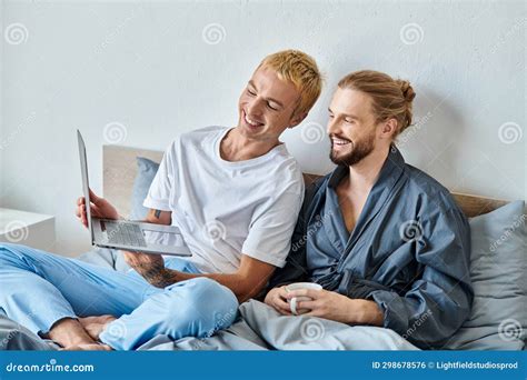 Joyful Gay Man Showing Laptop To Stock Photo Image Of Bedroom Connection