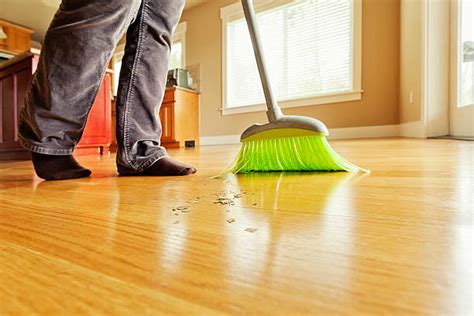 Person Sweeping Mess On Hardwood Floor With Broom Stock Photos