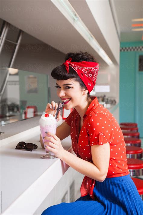 Stylish Rockabillypin Up Girl Enjoying Milkshake At Bar By Audrey