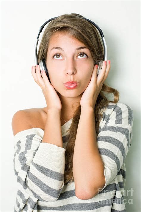 Beautiful Young Brunette Listening To Music With Headphones Photograph