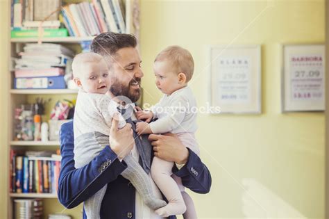 Young Father Hugging His Daughters As He Gets Home From Work Royalty Free Stock Image Storyblocks