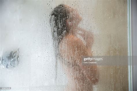 Young Woman In Shower Behind Steamed Glass Door Photo Getty Images