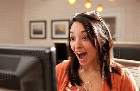 Surprised Hispanic Woman Using Computer Stock Photo Dissolve