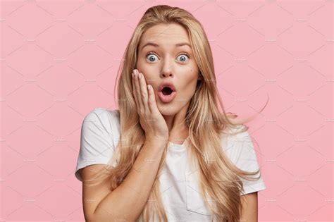 Indoor Shot Of Stupefied Shocked Blonde Woman Keeps Mouth Widely Opened