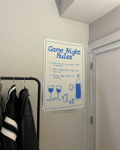 There Is A Sign On The Wall That Says Game Night Rules And Two Coats
