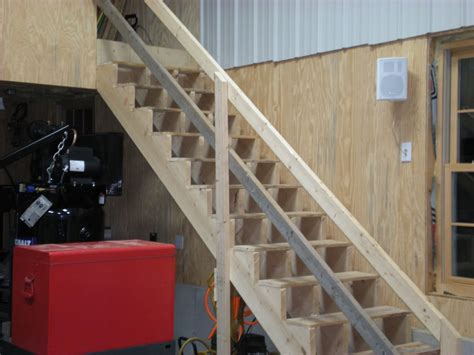 A Set Of Stairs Leading Up To A Room With A Red Box On The Floor