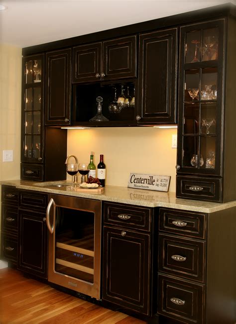 Dark walnut wood and metal bar cabinet with wine bottle storage. Bar Cabinetry - Wudwurks Custom Cabinets