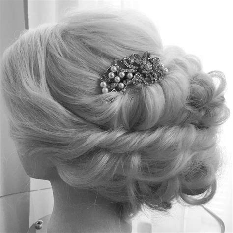 A Womans Hair Is Styled In A Low Bun With Pearls And A Brooch