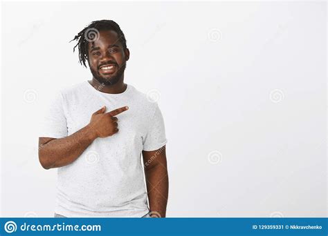 Studio Shot Of Happy Pleased Attractive Dark Skinned Guy In White T