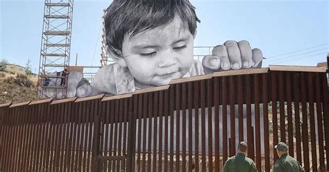 Street Artist Jr Installs Massive Face Of A Child On Mexican Side Of Us