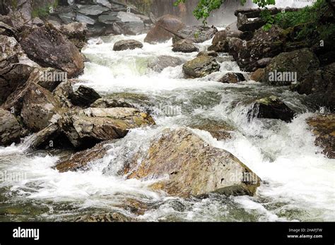 A Stormy Stream Of A Fast Moving River Flows Through A Mountain Hollow