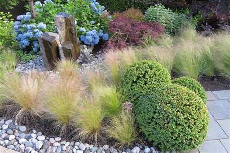 Boxwood Spheres And Ornamental Grasses Garden Design Ornamental