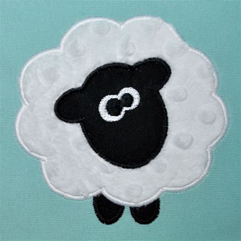 A Black And White Sheep Is Standing In Front Of A Blue Background With