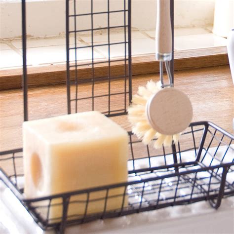 Before i ever tackle organizing our kitchen cabinets and drawers, i start by taking everything out and sorting the items. kitchen sink tidy with brush by dibor | notonthehighstreet.com