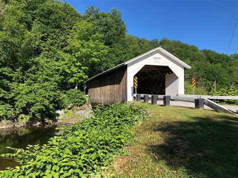 Comstock Covered Bridge In Montgomery Vermont Spanning Trout River