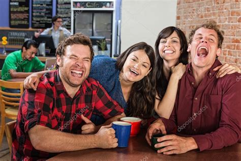 Stock Photo Friends Laughing Woman Laughing As She Embraces Her