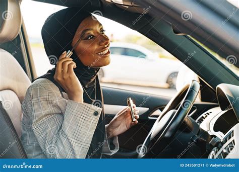 Black Muslim Woman Applying Mascara While Looking At Mirror Stock Image