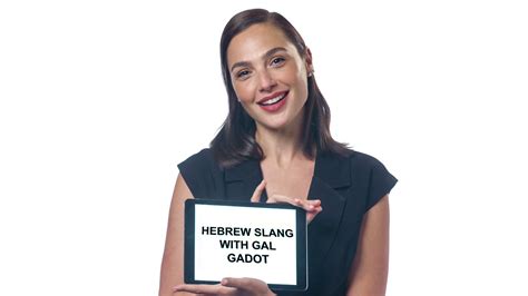 A Woman Holding Up A Sign That Says Heifern Slang With Gal Gadot