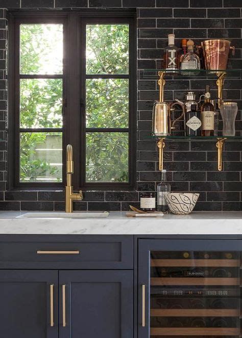 4.6 out of 5 stars. Black brick walls and blue cabinets and drawers with gold handles for kitchen design is ...