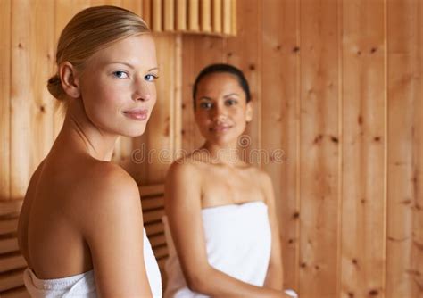 Letting The Sauna Relax And Pamper Them Two Friends Enjoying The Sauna