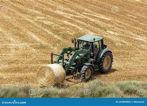 High Angle Shot Of John Deere Tractor Lifting A Hay Bale In An Open
