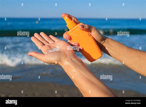 Close Up Of Woman Applying Suntan Lotion Sand Beach Blue Sea Background Stock Photo Alamy
