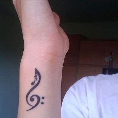 Music notes tattoo on back neck. 32 Beautiful Music Note Tattoos -DesignBump