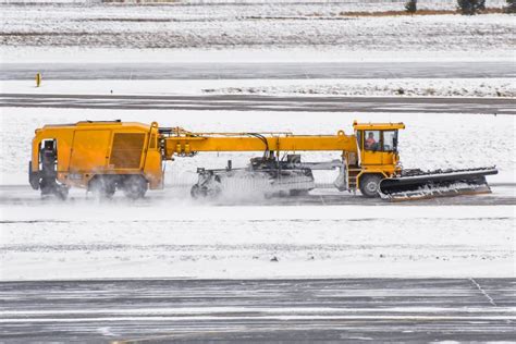 Large Snow Plowing Machine At Work On The Road During A Snow Storm In