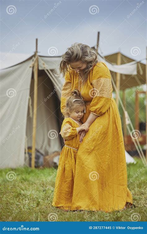 Beautiful Woman With Her Daughter Dressed In Embroidered Dresses Stock