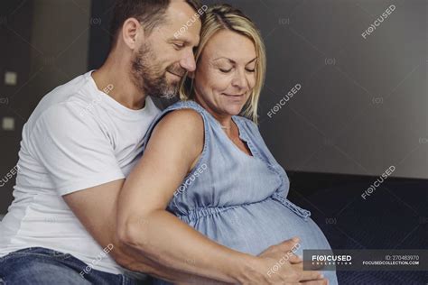 Mature Man And Pregnant Mature Wife Sitting On Bed And Touching Belly — Contemplation Female