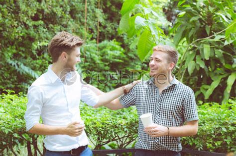 Two Friends Men Talking Standing In A Garden Stock Photo 1119027