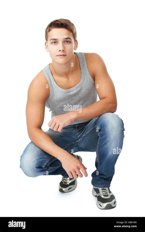 Portrait Of Young Man Squatting Isolated On White Background Stock