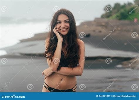 Portrait Of Tanned Smiling Girl With Closed Eyes In Swimsuit Resting On